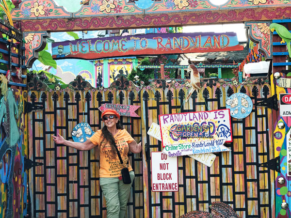 Karen Duquette at The entry gate to Randyland
